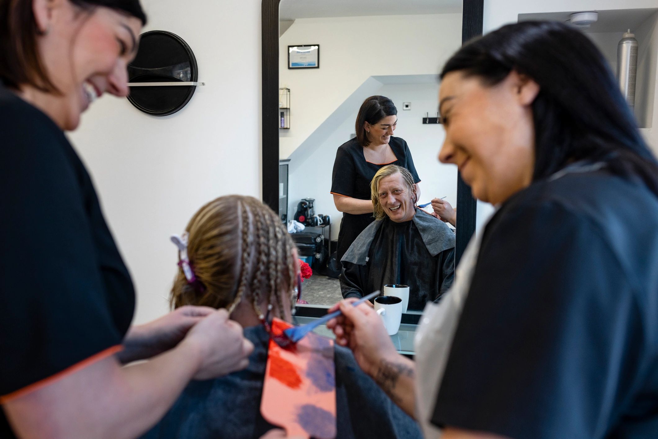 Salon team working on hair color and styling